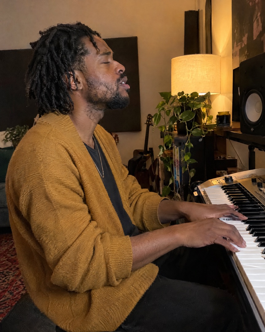 Keyboard player rehearsing at home with his eyes closed